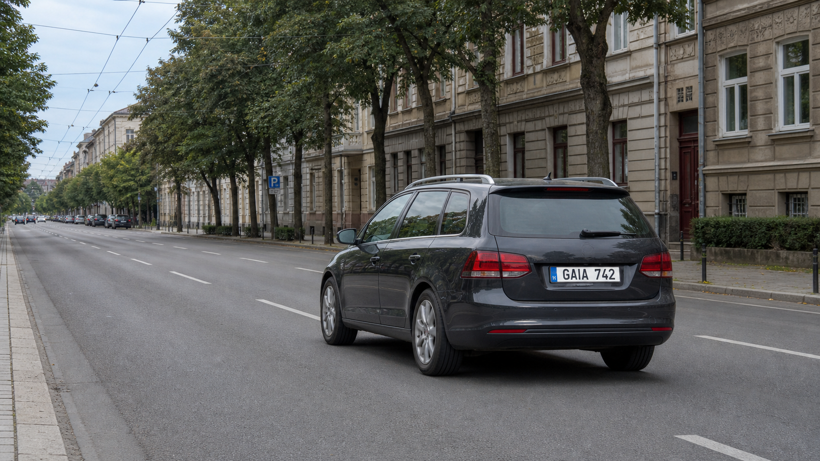 Fixed urban camera frame showing a dark vehicle in clear daylight.